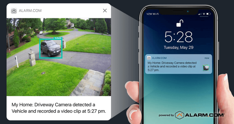 This image depicts a split-screen view: on the left, a drone captures a car in a driveway; on the right, a smartphone displays a notification about the recorded event.