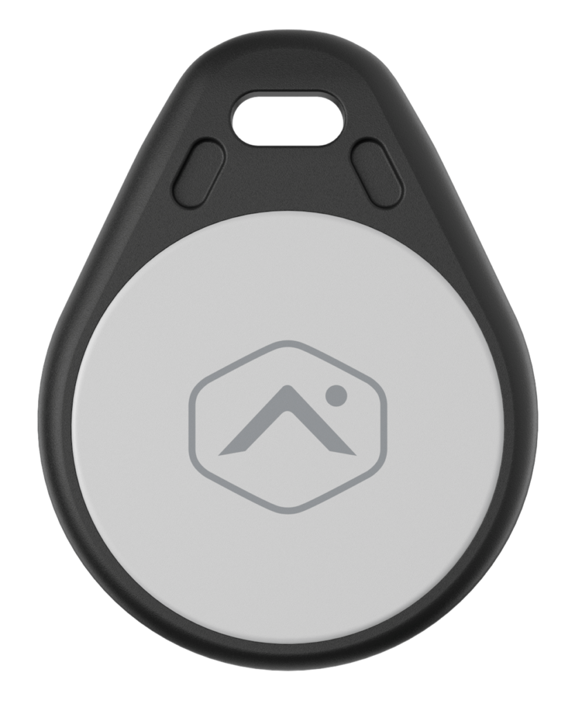 This image shows an oval-shaped electronic device, presumably a key finder or tracker, with a hexagon logo featuring a mountain and a circle.