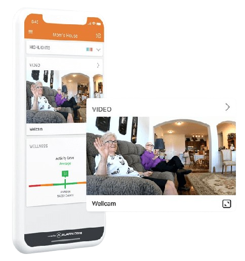 This image features a smartphone displaying an app monitoring the wellbeing of a person, who is seen sitting on a sofa in a living room.